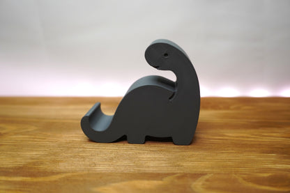 Dinosaurier-Handyhalterung auf dem Schreibtisch, funktional und dekorativ
