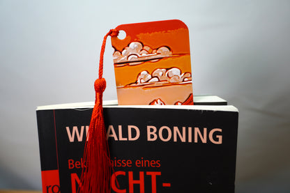 Nahaufnahme des Lesezeichens mit Berglandschaft und grasender Kuh im Vordergrund, wählbar mit Quaste