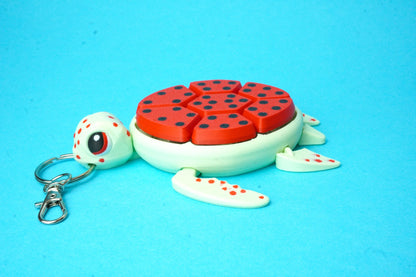 Fruit Turtle Clicker in Wassermelonen‑Optik am Schlüsselring befestigt